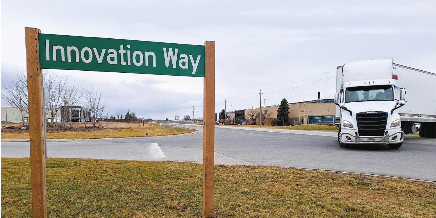 Street corner with Innovation Way sign and tracker trailer 